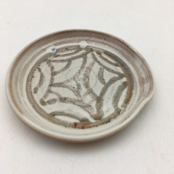 Tan spoonrest with iron oxide design by Margo Brown